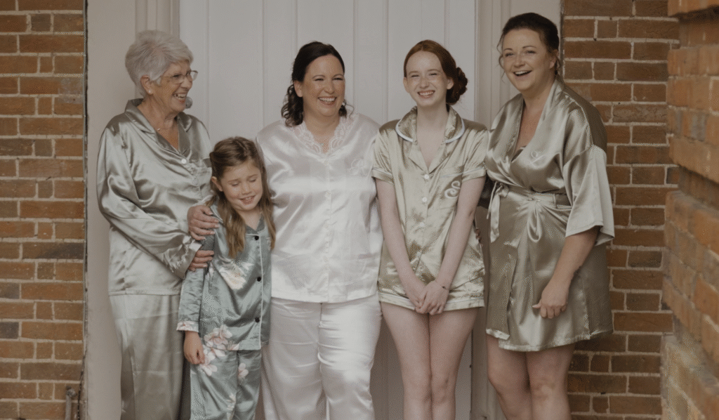 Ria and her bridesmaids giggling together outside the main building of Crowcombe Court in Somerset