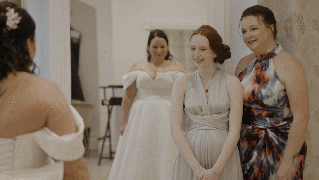 Ria's daughter and friend gazing in awe at Ria in her dress for the first time at Crowcombe Court