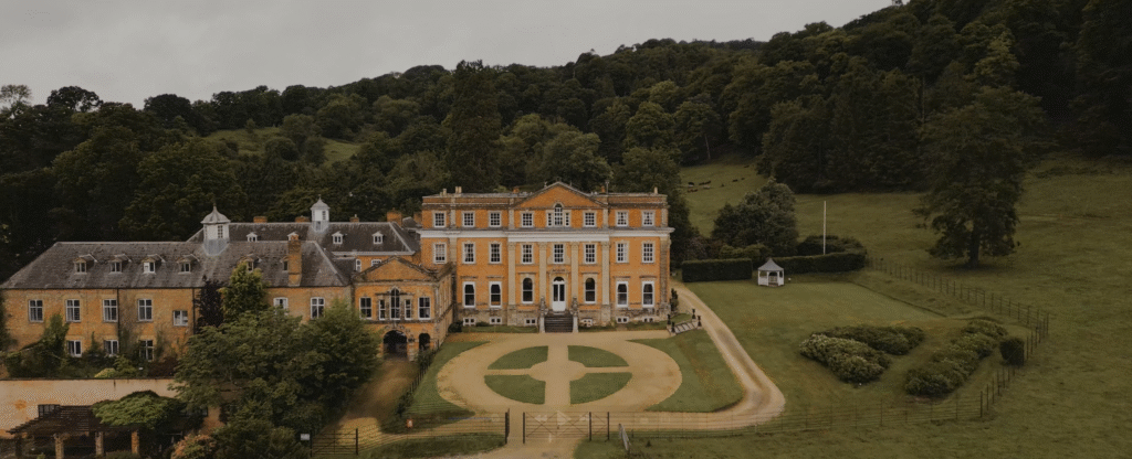Aerial drone shot of Crowcombe Court, Somerset head on with the greenery in the background